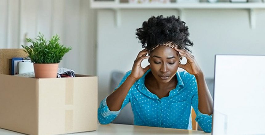 woman with her head in her hands in an office