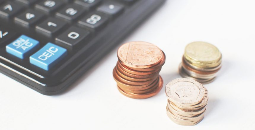 calculator and piles of coins