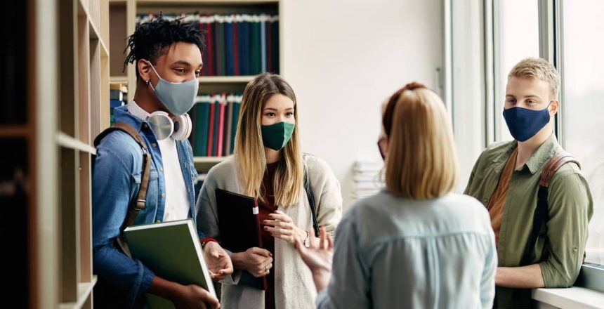 students wearing masks in a university library