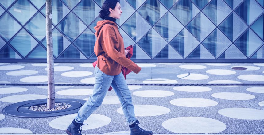 woman walking along a pavement