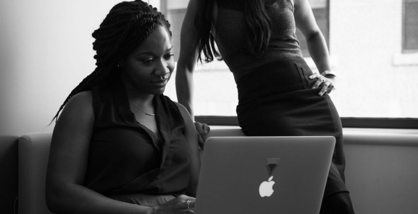 black and white image of business women looking at a laptop
