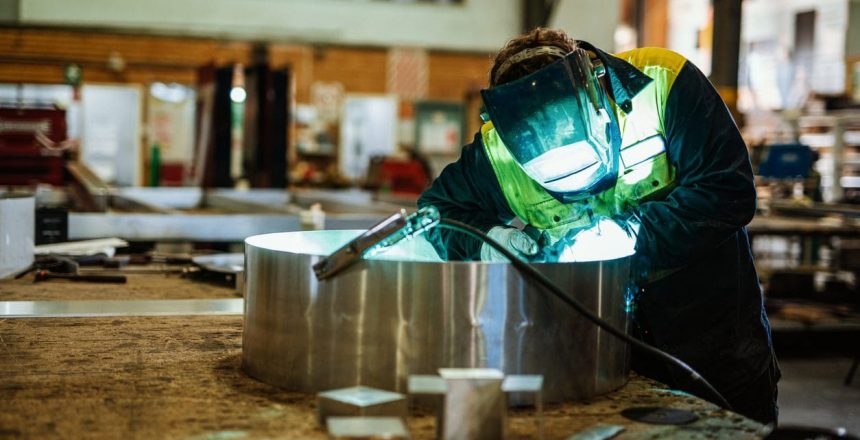 metal worker with protective face mask while working