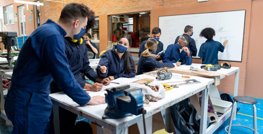 students in an engineering classroom enjoying the apprentice learning experience